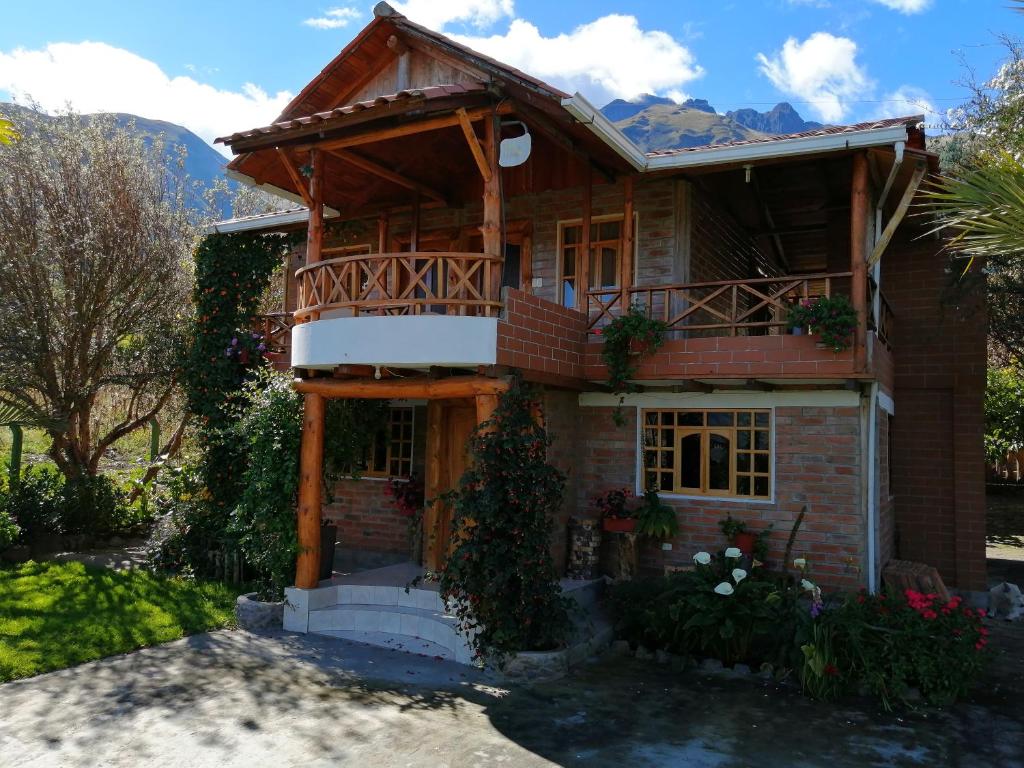 una casa con balcón en la parte superior en El Encanto del Taita Imbabura, en Otavalo