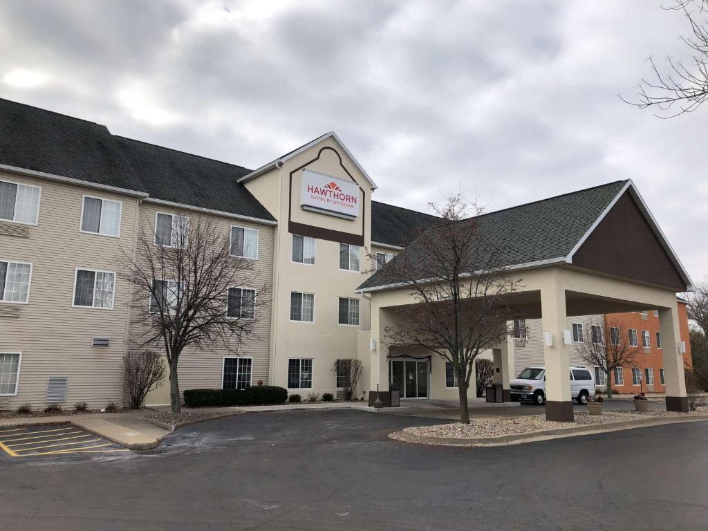 a hotel with a sign on the front of it at Hawthorn Suites by Wyndham Decatur in Decatur