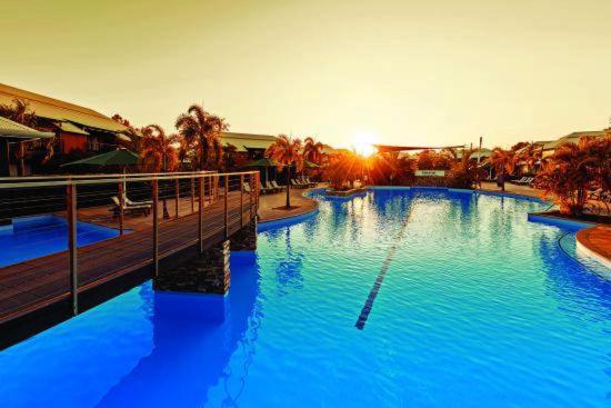 a large pool with blue water in a resort at Luxury Executive Apartment at Broome Cable Beach in Broome