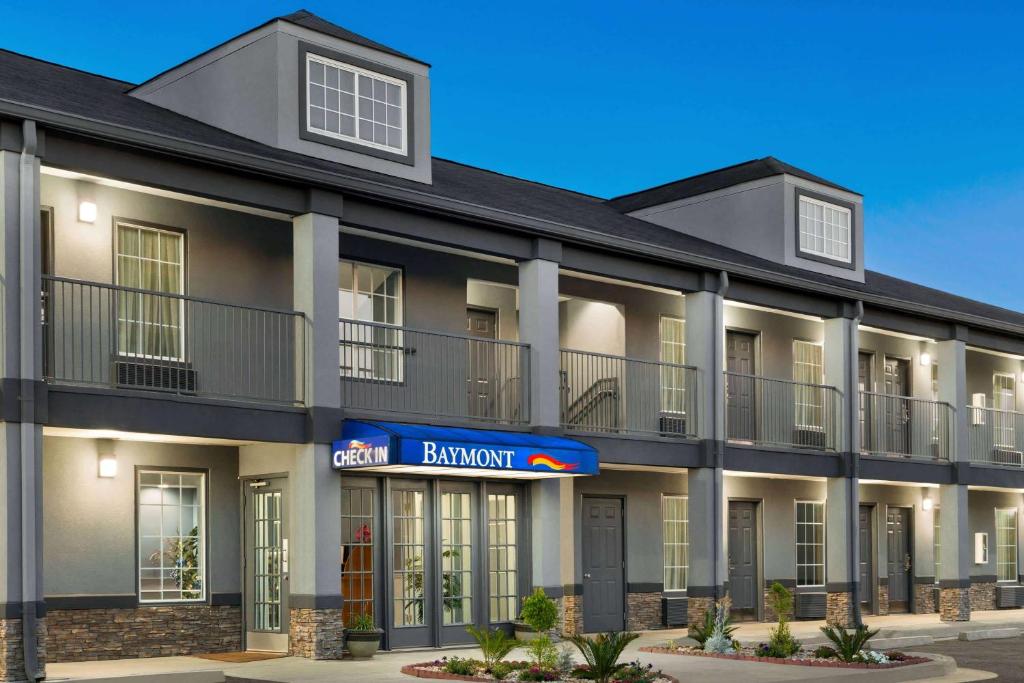 a rendering of the front of a building at Baymont by Wyndham Warner Robins in Warner Robins