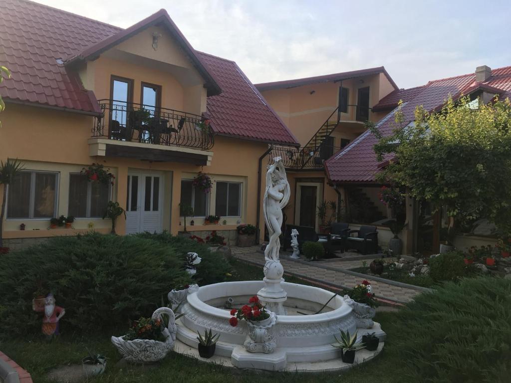 a statue in the yard of a house at Pensiunea Darius Costinesti in Costinesti