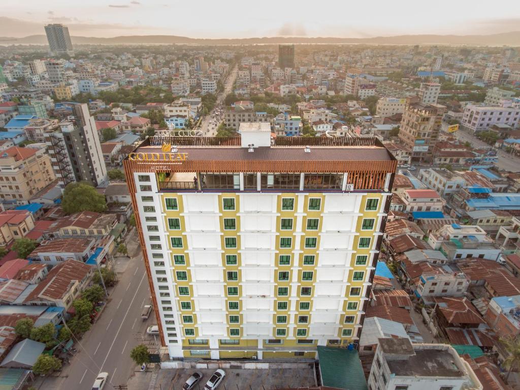 an overhead view of a white building with yellow windows at Gold Leaf Hotel in Mandalay