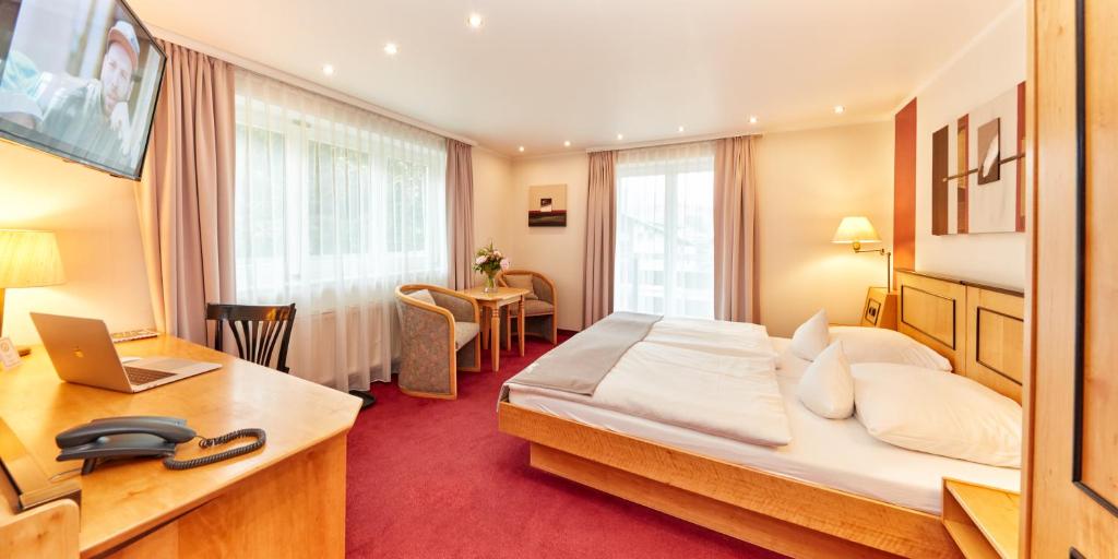 Postel nebo postele na pokoji v ubytování Hotel Riezler Hof