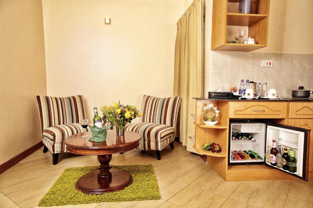 a living room with a table and two chairs at Longview Suites Hotel in Nairobi