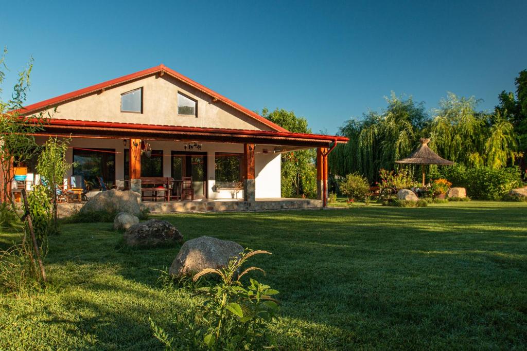 a house with a grass yard with at La Livada in Greci