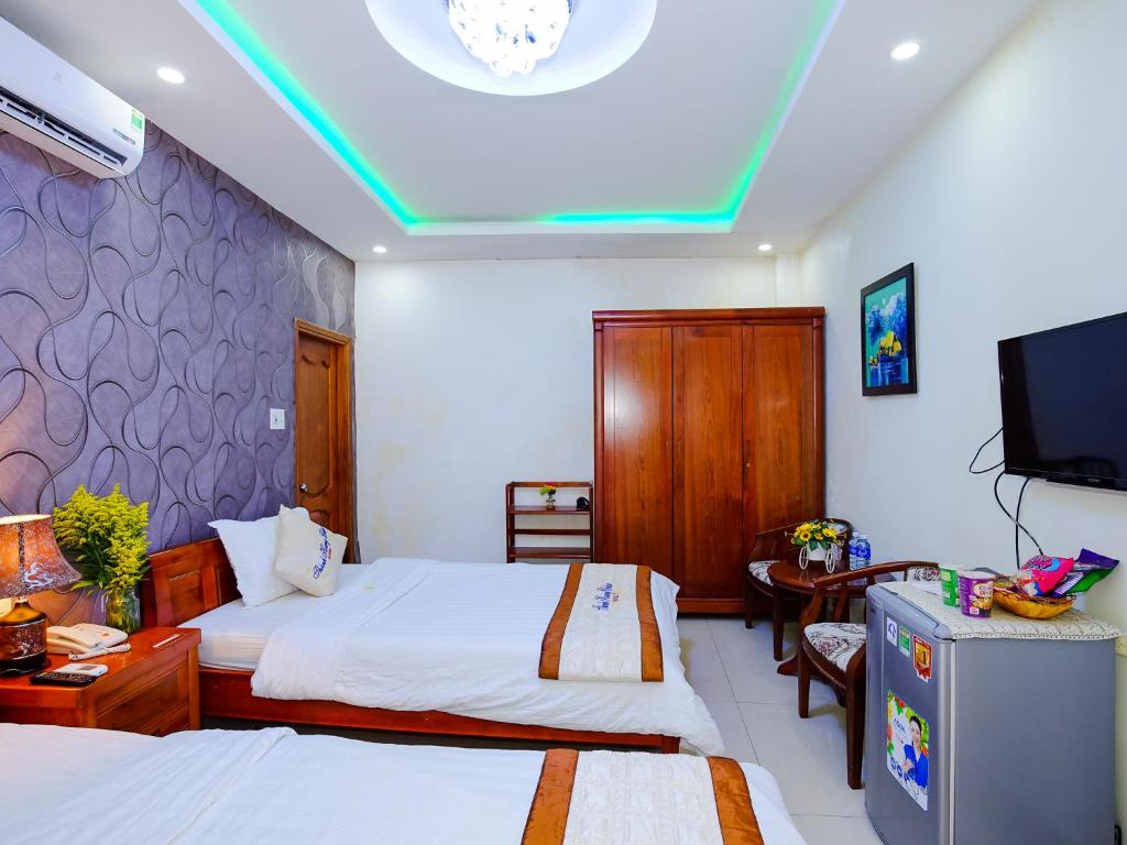 Postel nebo postele na pokoji v ubytování Thành Hoàng Châu Boutique Hotel