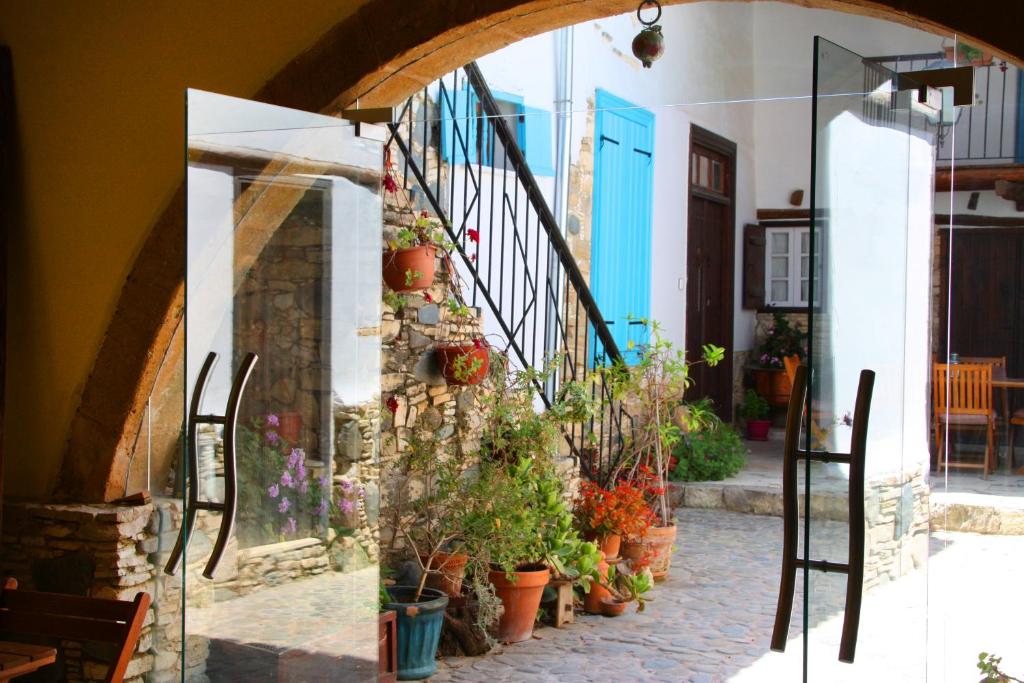 an entrance to a house with potted plants at Aperanti Agrotourism in Pera Orinis