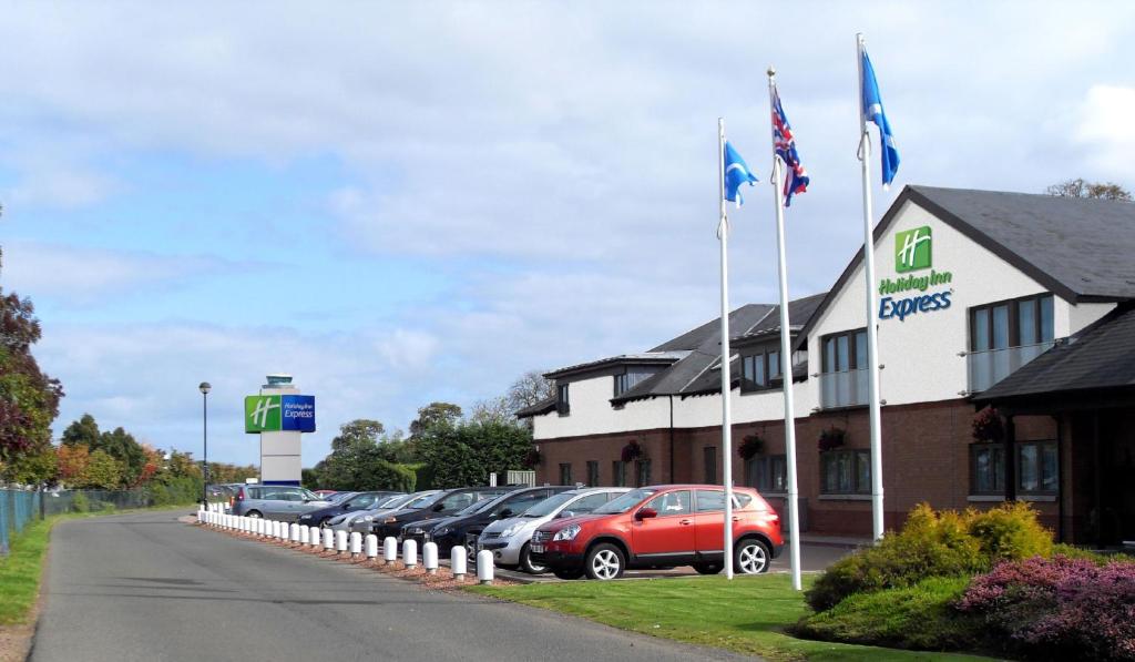 cars parked on the side of the road at Holiday Inn Express Edinburgh Airport, an IHG Hotel in Ingliston