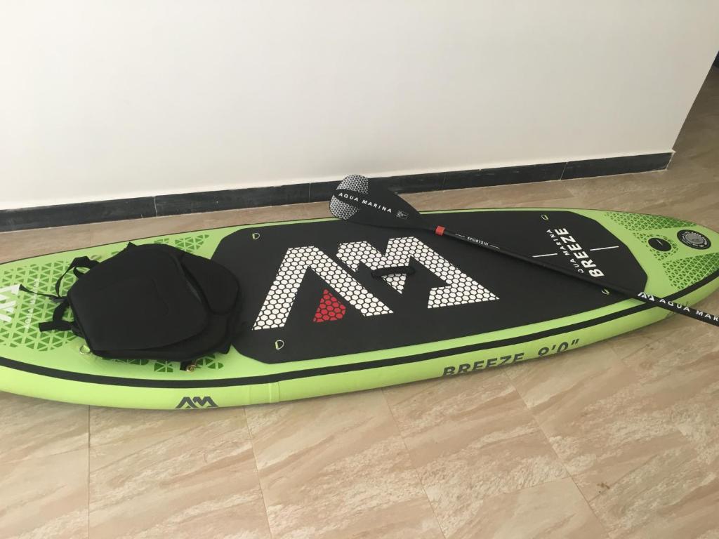 a paddle board sitting on the floor with a paddling device at Arabesque Style - 2 appartements in Kelibia