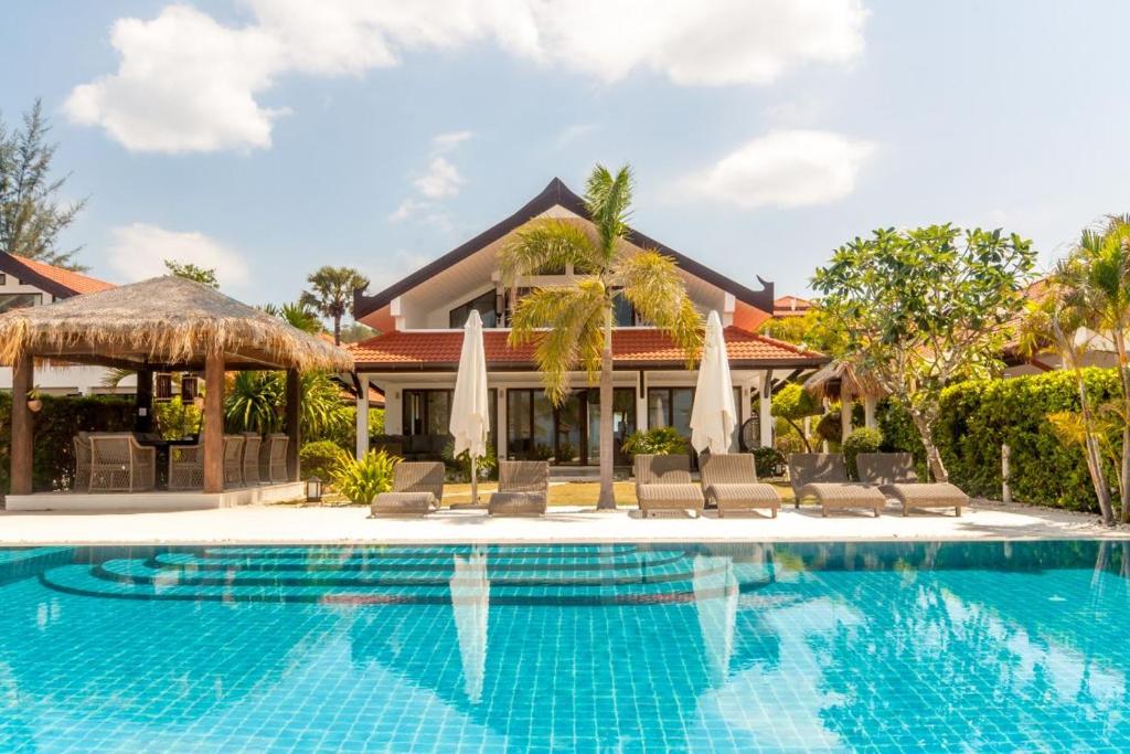 a swimming pool in front of a villa at Malee Beach A4 in Ko Lanta