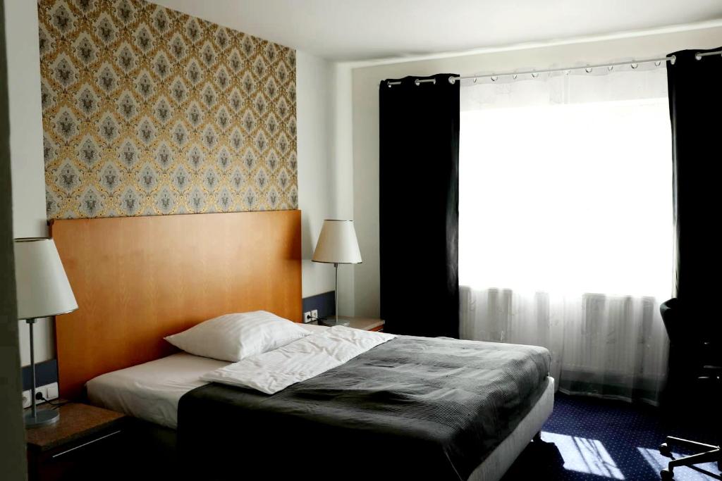 Postel nebo postele na pokoji v ubytování Hotel Dvůr