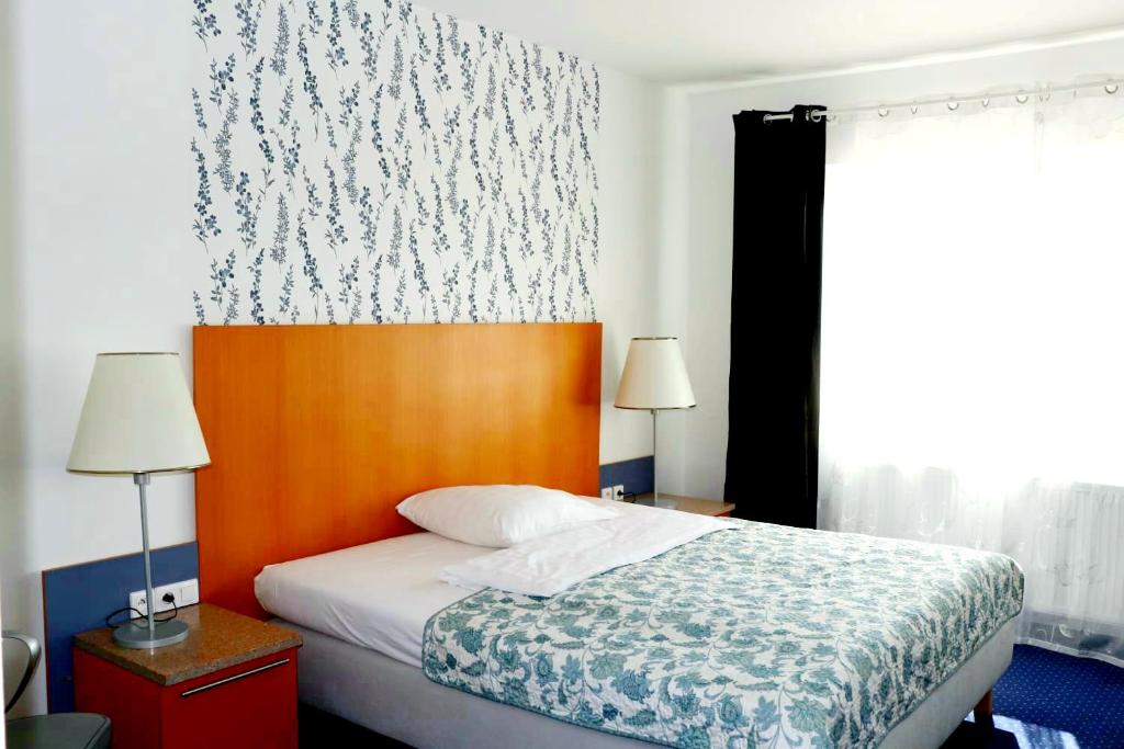 Postel nebo postele na pokoji v ubytování Hotel Dvůr