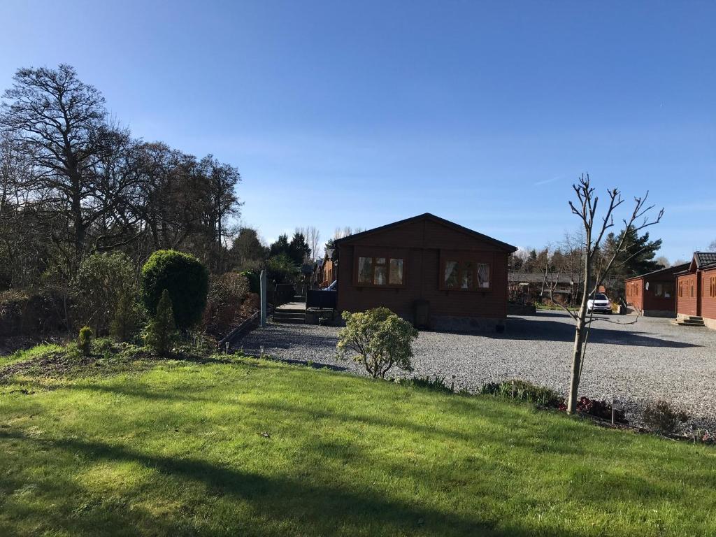 a house with a yard with a house at Grandeagles Extra large lodge in Auchterarder