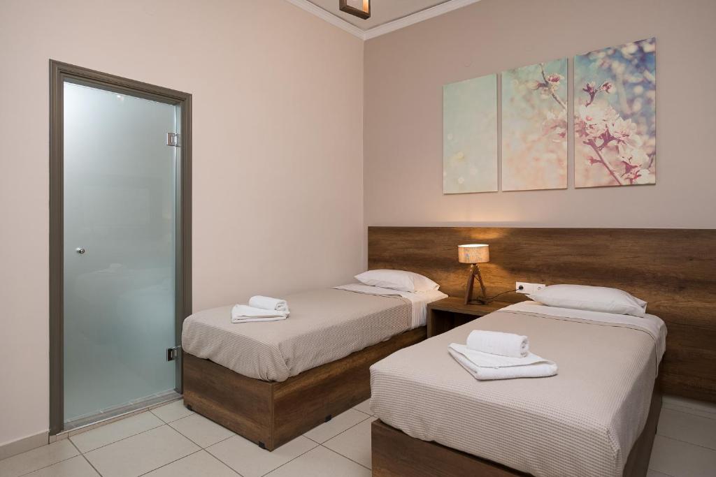 Postel nebo postele na pokoji v ubytování Olympic Hotel