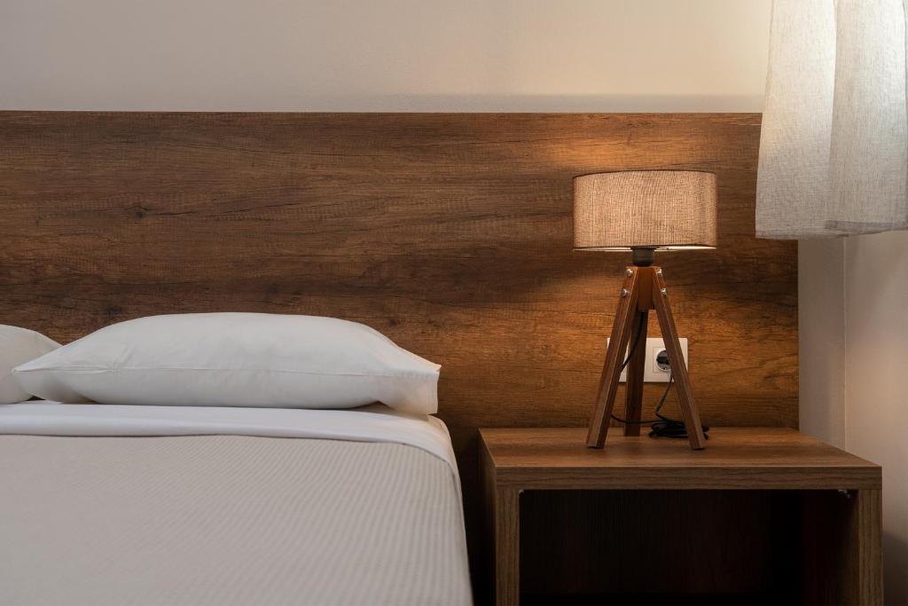 Postel nebo postele na pokoji v ubytování Olympic Hotel