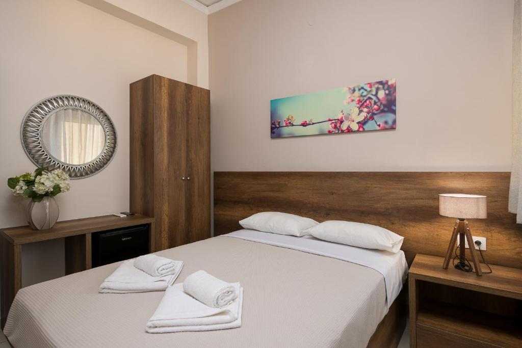 Postel nebo postele na pokoji v ubytování Olympic Hotel
