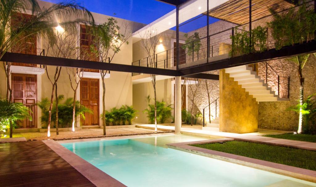 an external view of a house with a swimming pool at Casa de Las Palomas Boutique Hotel by Paloma's Hotels - Adults Only in Mérida