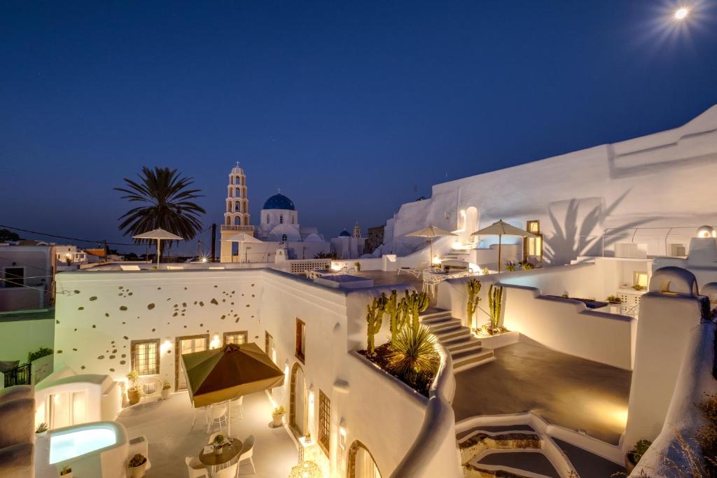 a view of a white building at night at Radiant Santorini in Mesaria