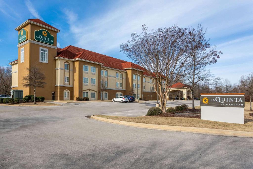 a large building with a clock on the front of it at La Quinta by Wyndham Huntsville Airport Madison in Madison
