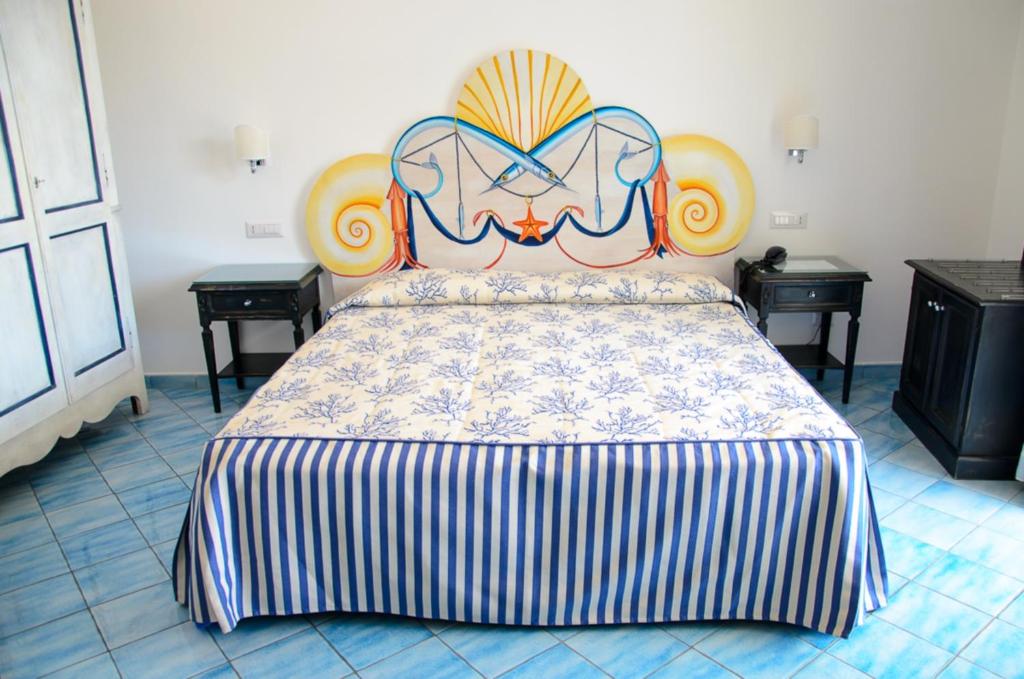 a large bed with a headboard in a room at Palazzo Marzoli charme Resort - Small Luxury Hotel in Positano