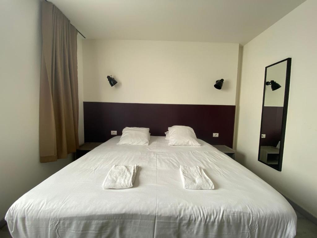 Postel nebo postele na pokoji v ubytování Hotel O Ieper