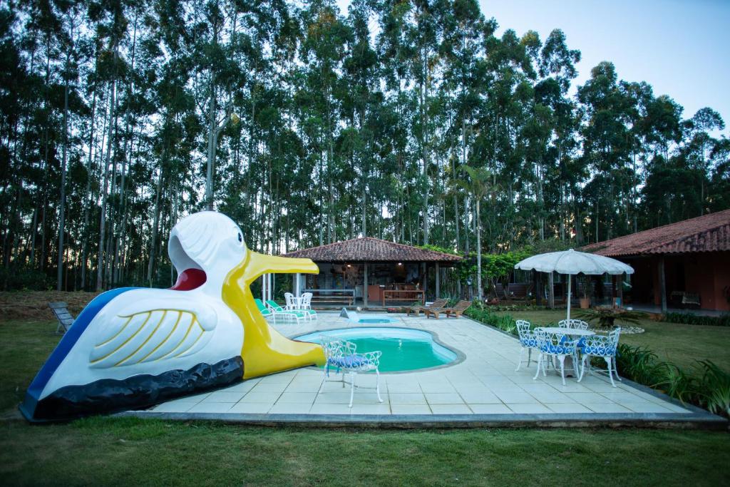 a large plastic duck statue next to a pool at Sítio Nicolau - Maravilhoso sítio nas Montanhas em Domingos Martins! in Domingos Martins