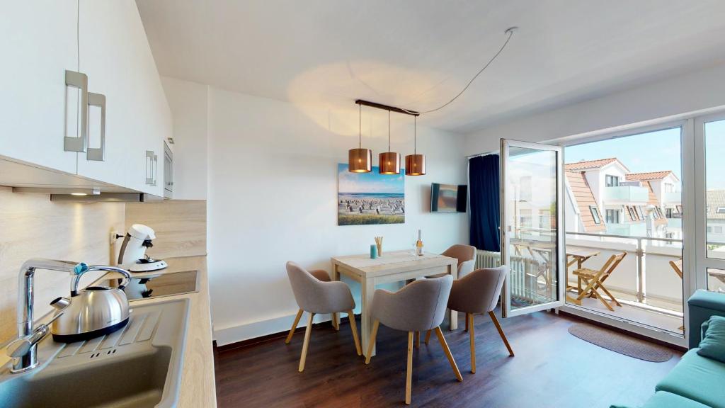 a kitchen and living room with a table and chairs at Strandnahe, moderne Ferienwohnung auf Wangerooge, Seeluft 34 in Wangerooge