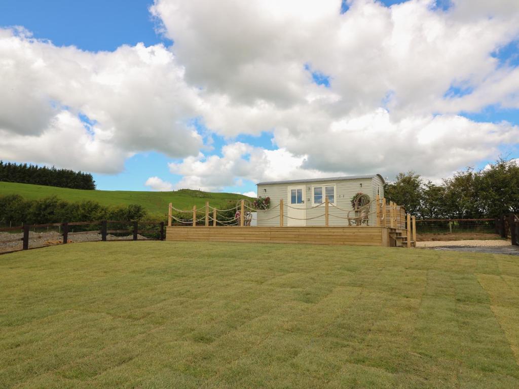 a house in the middle of a grassy field at Marches Way in Rhayader