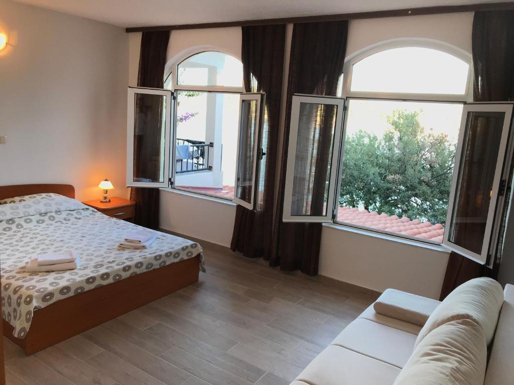 Posteľ alebo postele v izbe v ubytovaní Apartmani Ružica