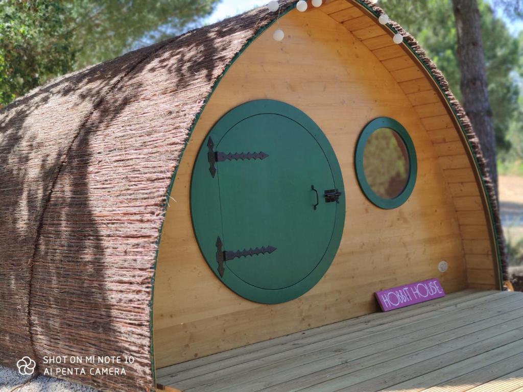 a dog house with two doors on a wooden deck at Quinta Alada in Montemor-o-Novo