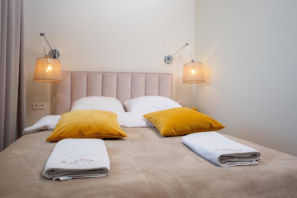 Posteľ alebo postele v izbe v ubytovaní KaZou Residence