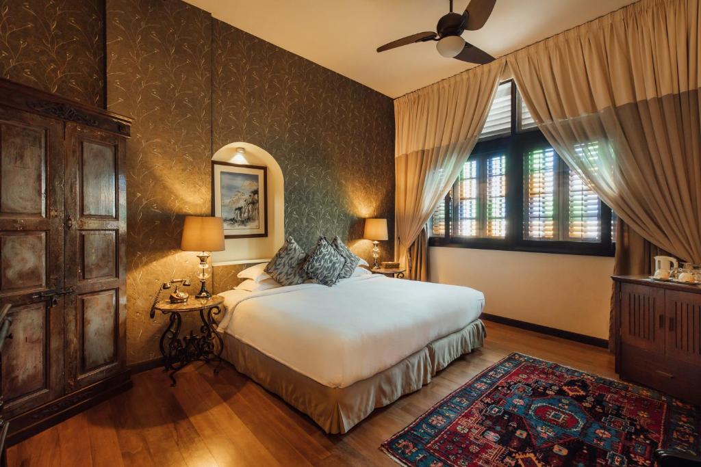 a bedroom with a bed and a large window at Campbell House in George Town