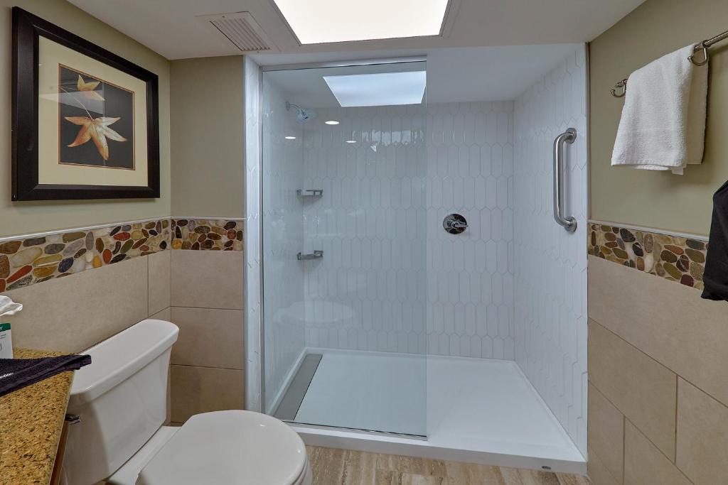 a bathroom with a shower and a toilet at The Inn On The River in Pigeon Forge