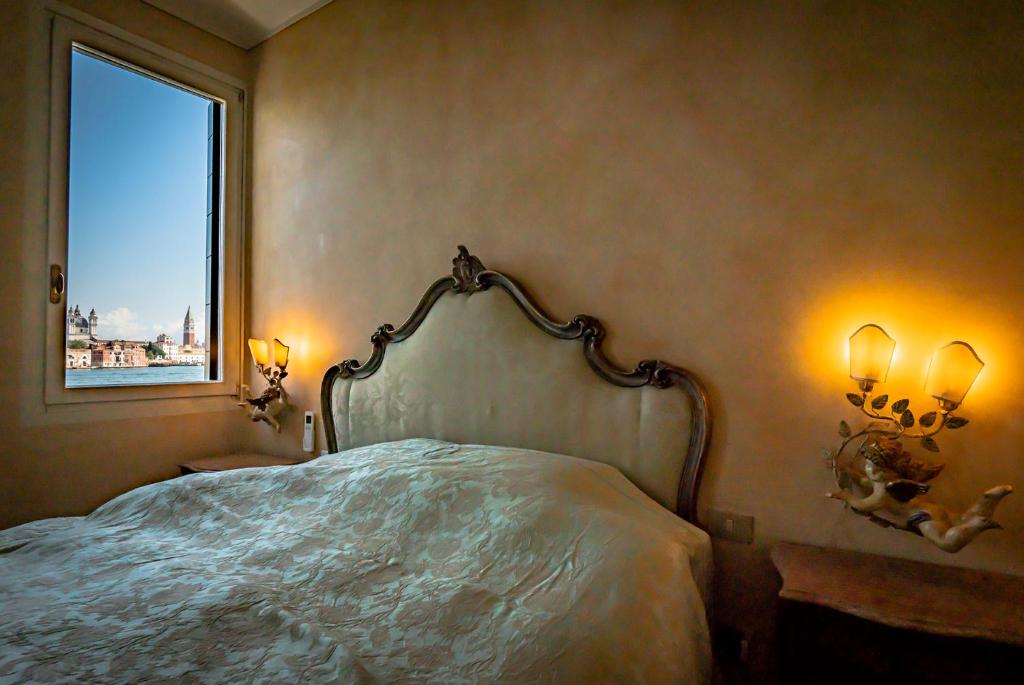 a bedroom with a large bed with a window at Apartment Dorotea Venice view in Venice
