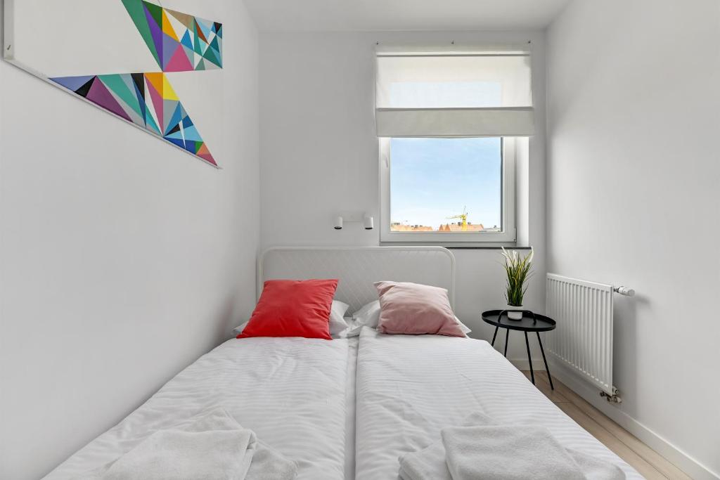 Posteľ alebo postele v izbe v ubytovaní Apartamenty Świętej Barbary
