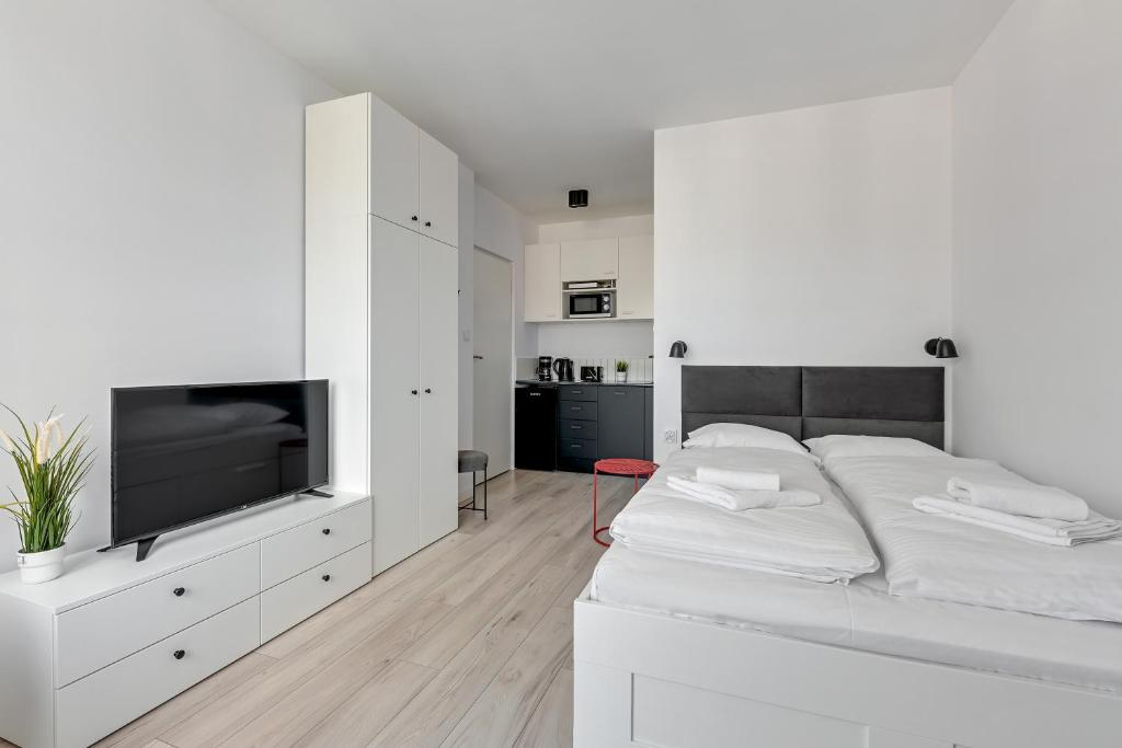 Posteľ alebo postele v izbe v ubytovaní Apartamenty Świętej Barbary