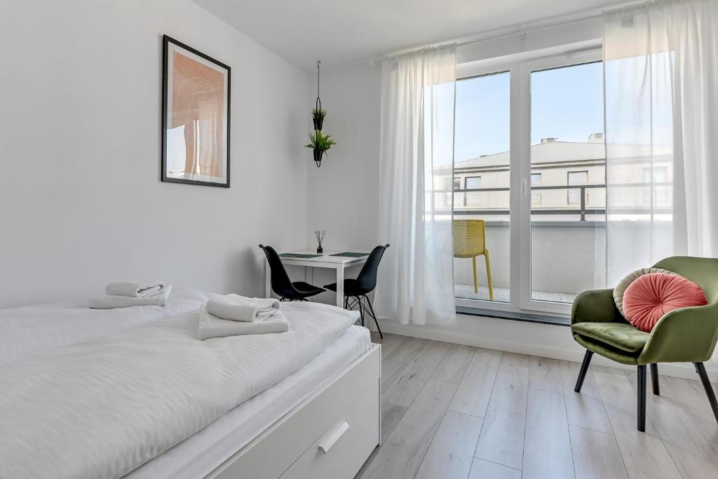 Posteľ alebo postele v izbe v ubytovaní Apartamenty Świętej Barbary