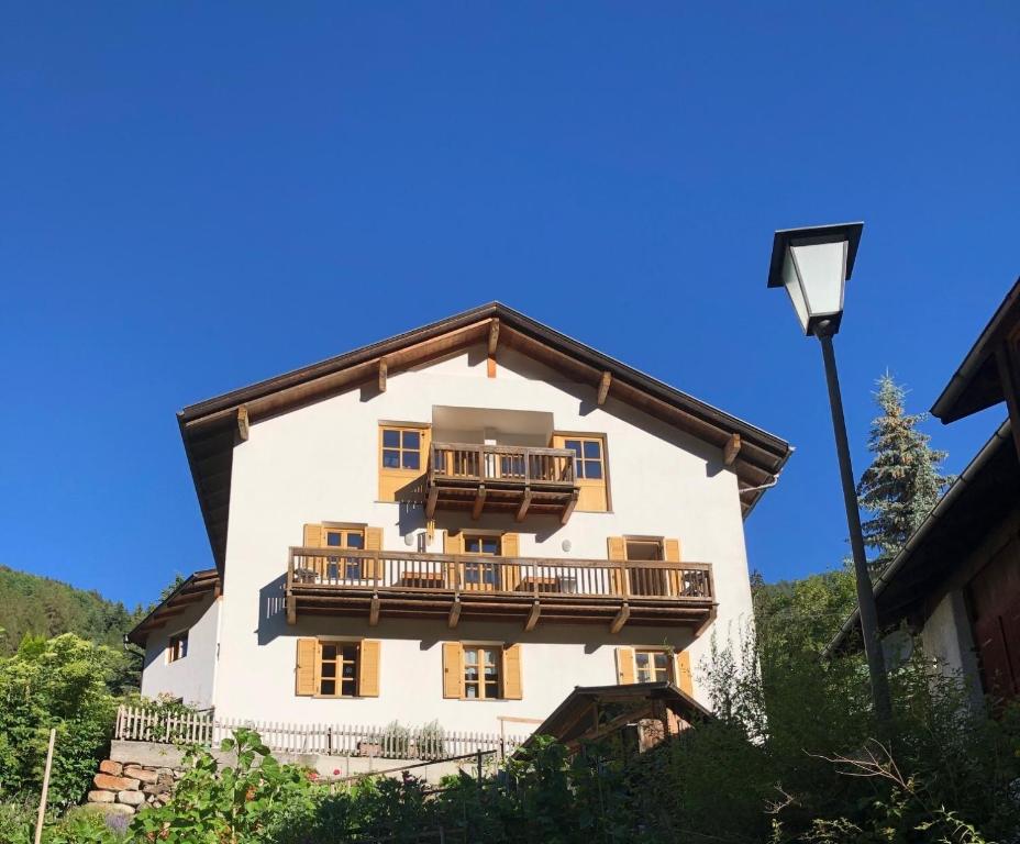 a large white building with a balcony on it at Haus Thoma in Stelvio