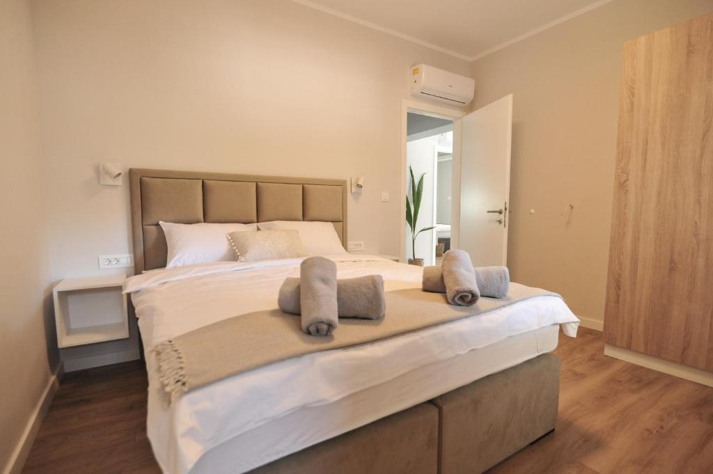 a bedroom with a large bed with towels on it at Tony's house with private pool, garden and parking in Zadar