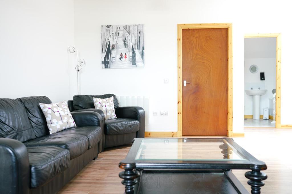 a living room with a couch and a coffee table at Millburn Apartments in Inverness