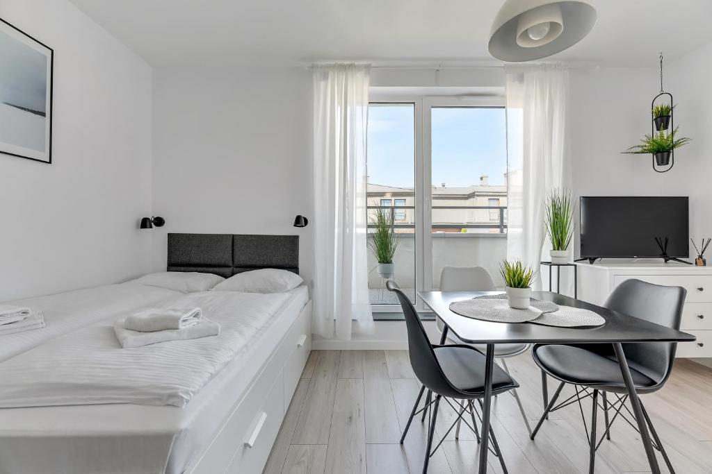 Posteľ alebo postele v izbe v ubytovaní Apartamenty Świętej Barbary