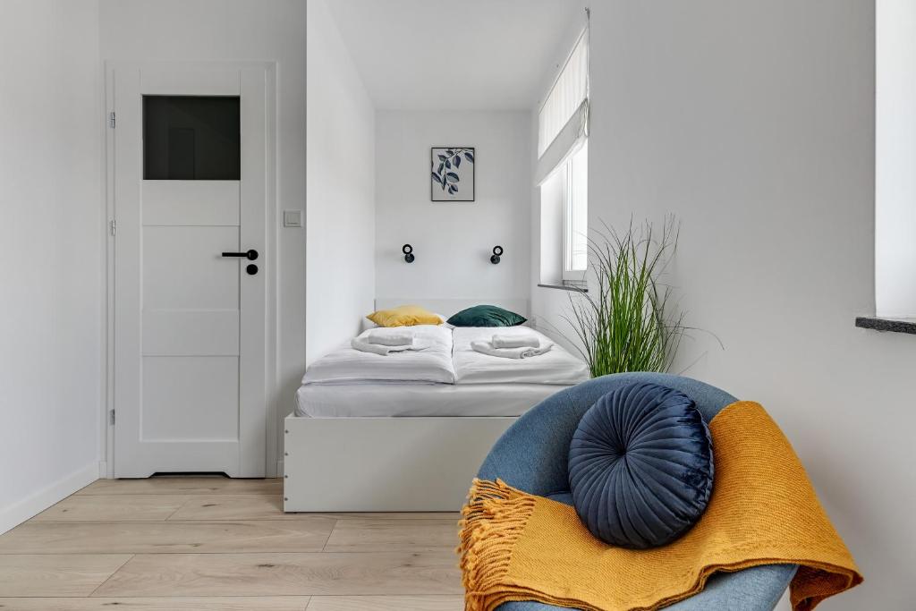 Posteľ alebo postele v izbe v ubytovaní Apartamenty Świętej Barbary