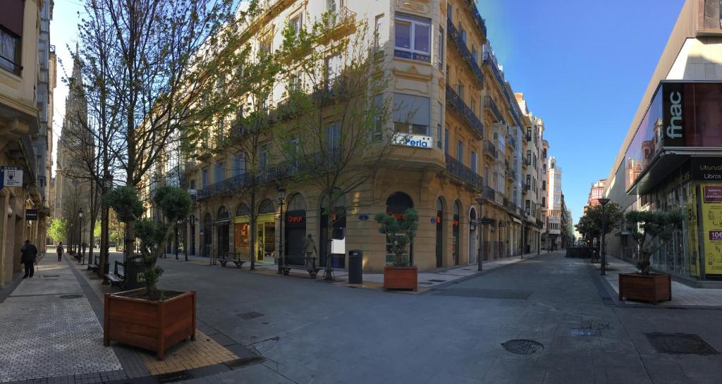 a street scene with a building and a street sign at Pensión La Perla in San Sebastián