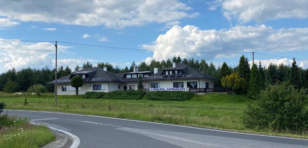 a house sitting on the side of a road at Zajazd Maj in Bolesław