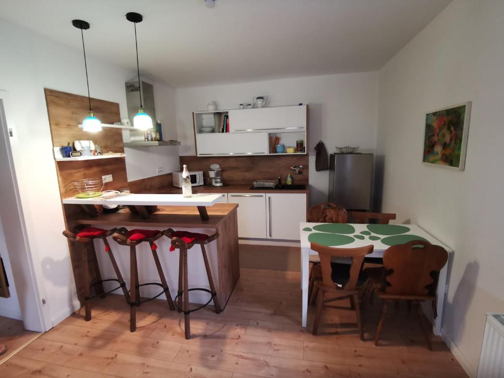 a kitchen with a table and two chairs and a table and a kitchen with at Im Herzen des Kraichgaus 1 in Östringen