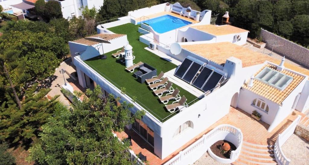 an aerial view of a house with a swimming pool at Villa on the Beach by GalanteVasques in Carvoeiro