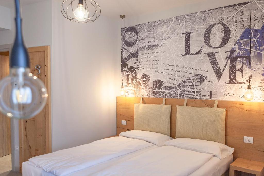 Postel nebo postele na pokoji v ubytování epOche Hotel Zanella 1889