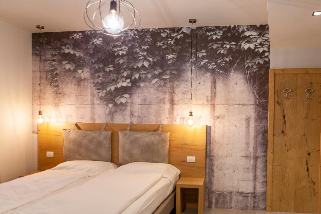Postel nebo postele na pokoji v ubytování epOche Hotel Zanella 1889