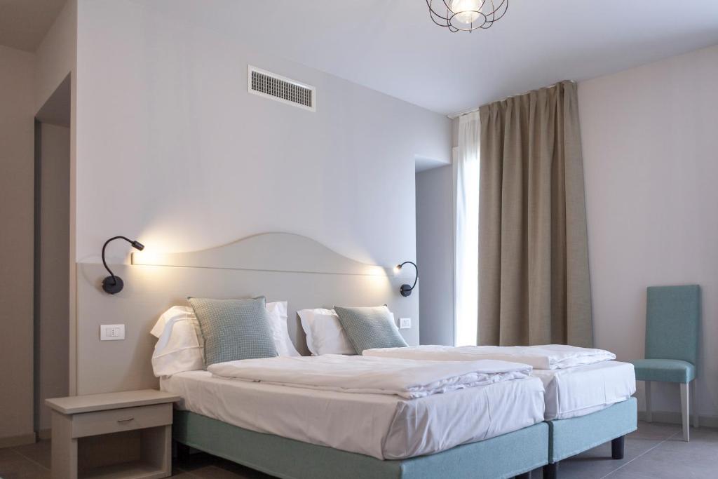 Postel nebo postele na pokoji v ubytování epOche Hotel Zanella 1889