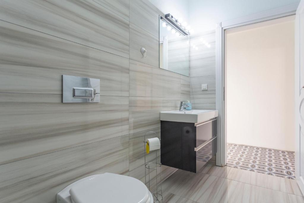 a bathroom with a toilet and a sink at EV Apartments in Belek